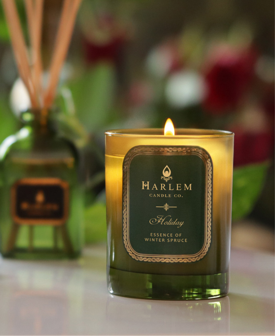 Holiday Candle on a white table with the Holiday Diffuser.