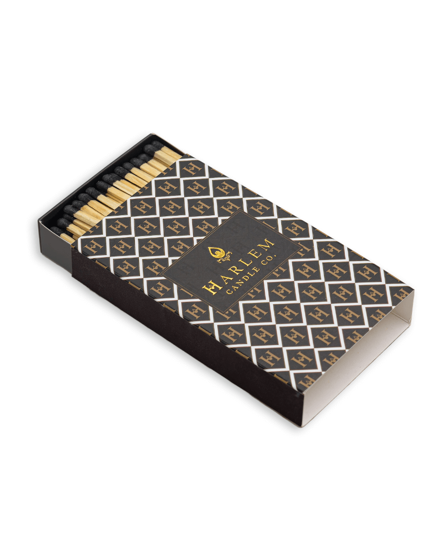 Match box containing 3 inch matches with black tips. The box has the Harlem H pattern in an art deco style printed on the box.