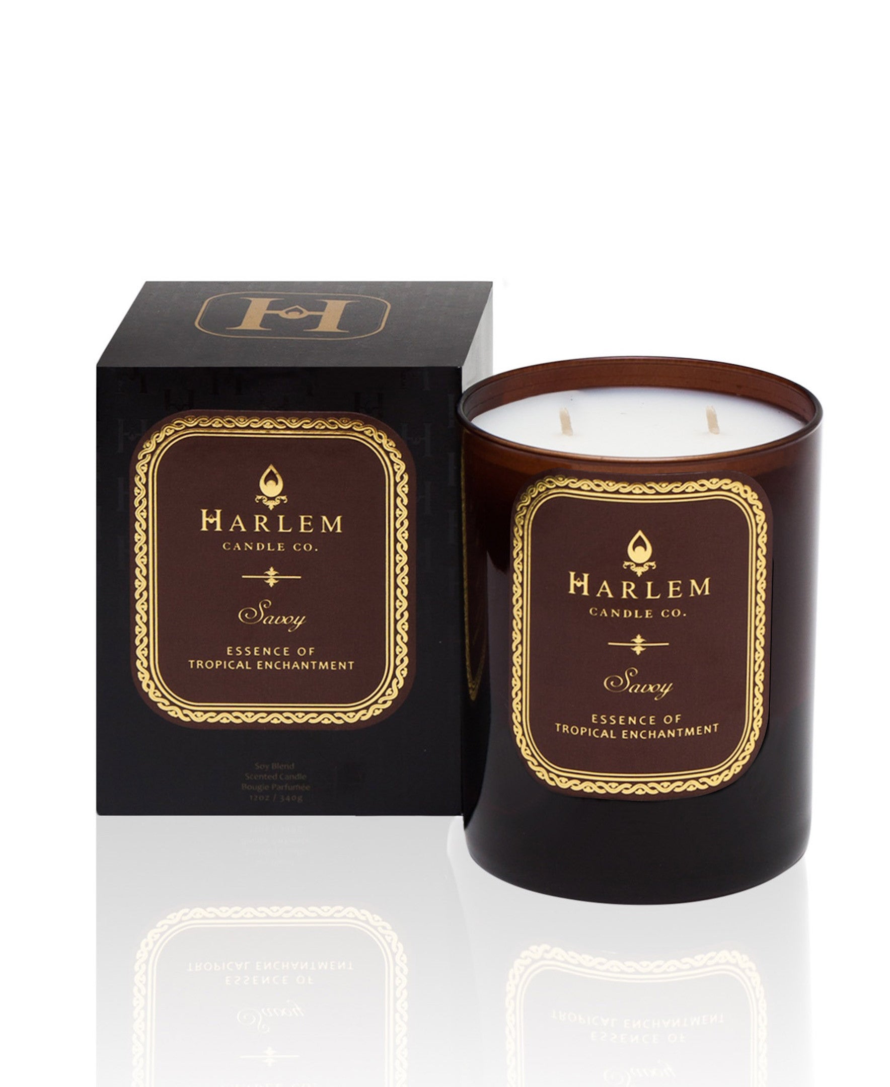 This is a photo of the Savoy Luxury Candle. This candle is scented with ozone, cassis, mandarin, lily of the valley, pear, apple, jasmine, musk and sandalwood on a white background sitting next to the decorative box.