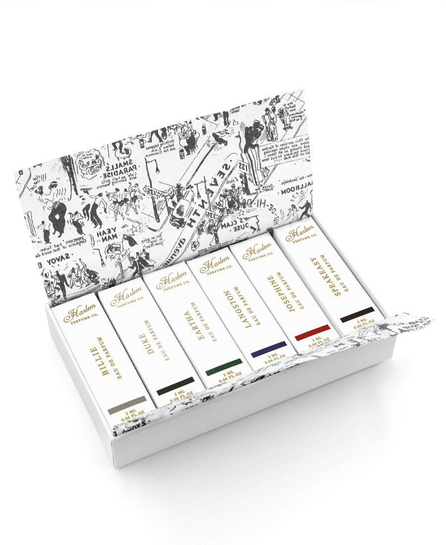 This is an image of our discovery set of six 2ml eaux des parfums samples featuring Billie, Duke, Eartha, Josephine, Langston, and Speakeasy.  This image features the Nightclub Map of Harlem tissue paper the samples are wrapped in.
