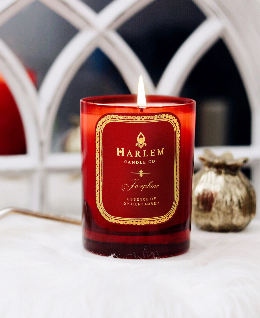 Josephine 1 Wick Candle on a white table with gold ornaments and a mirror.