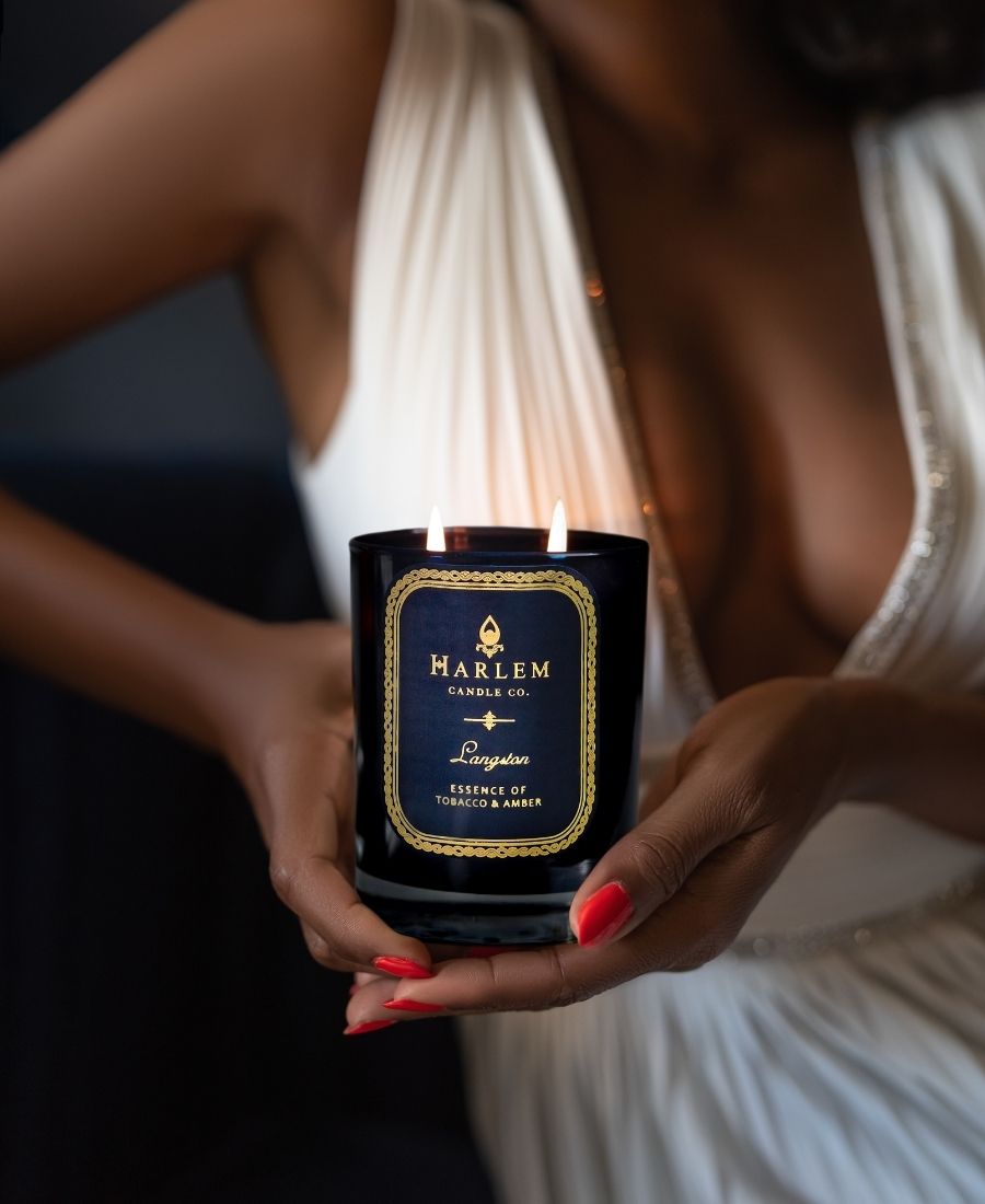 Woman in a white dress holding the Langston Candle.