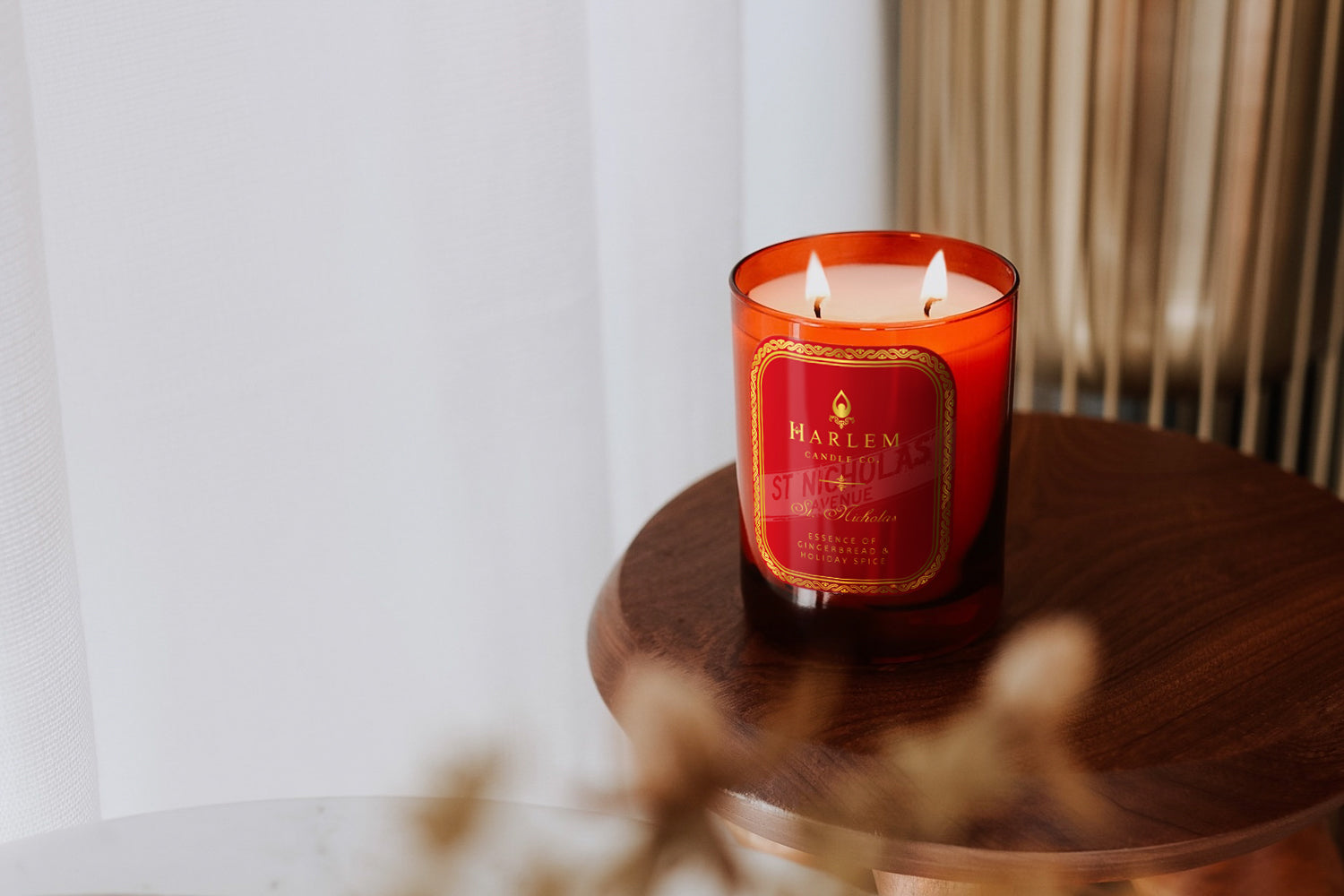 This is a lifestyle image of our St. Nicholas candle on a wooden table.